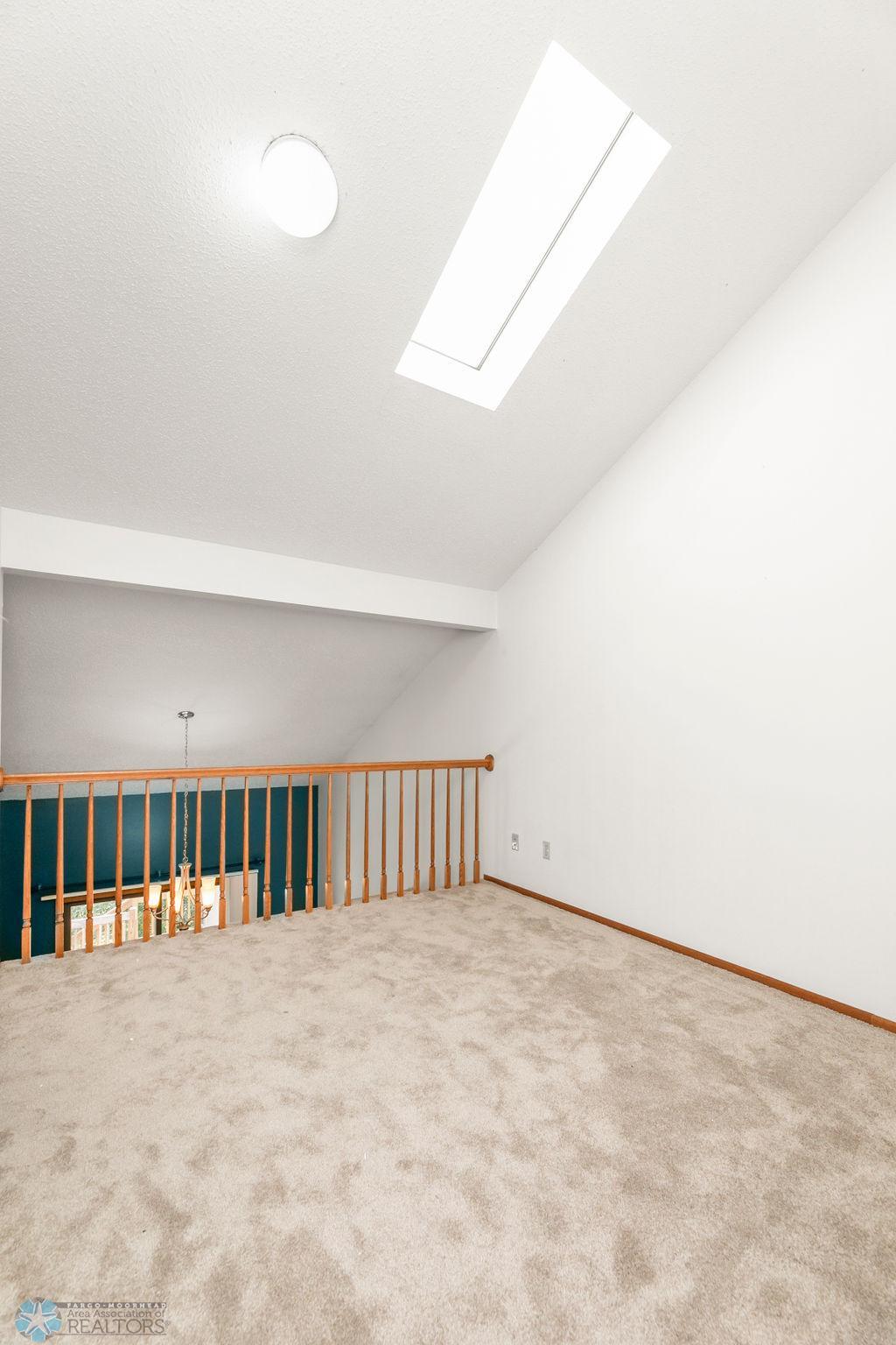 Family Room w/ Skylight overlooks Dining, Kitchen, Living