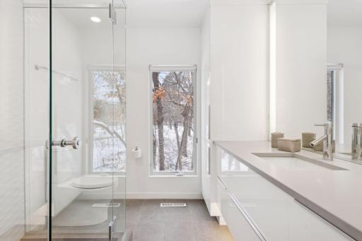 Glass enclosed shower in the second primary bathroom