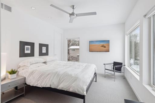 Second primary bedroom on the upper level, featuring a walk-in closet and private bathroom suite