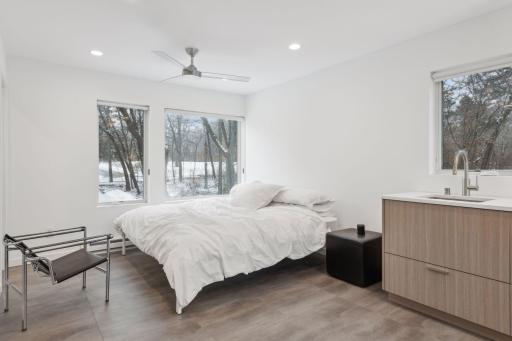 Bedroom with large windows and a walk-in closet in the ADU
