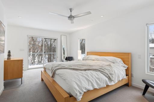 First primary bedroom suite on the upper level, featuring a private deck