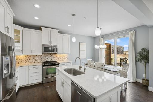Solid surface counter tops and a tile backsplash add contemporary elegance to the kitchen.