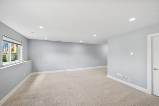 Recessed lighting and windows provide a bright lower level.