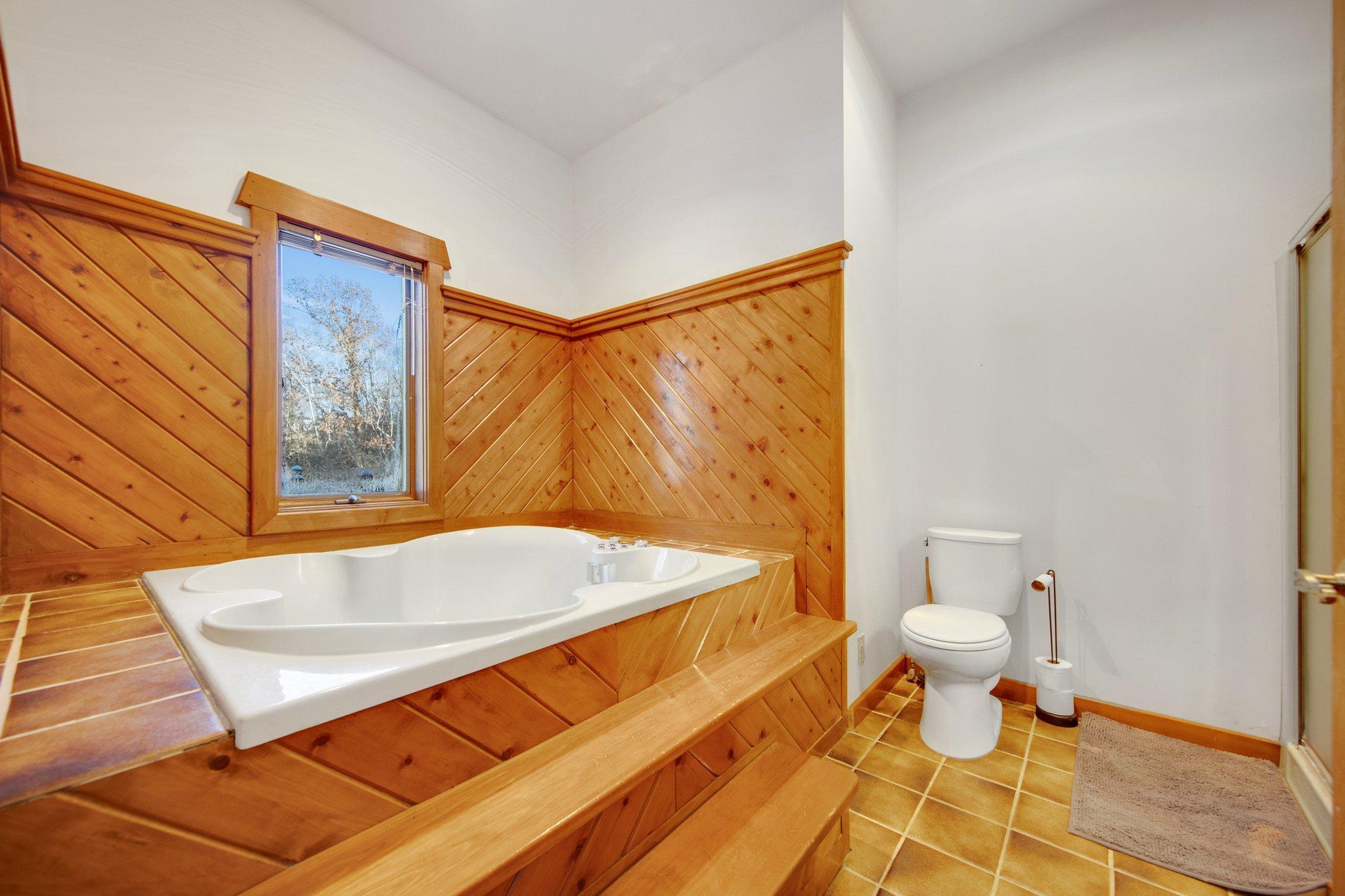 Full primary bathroom with separate tub and shower.