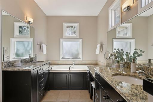 Large double sink primary bathroom with soaking tub