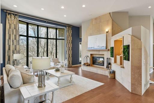 The see through wood burning fireplace adds warmth and ambiance to the living room and the kitchen