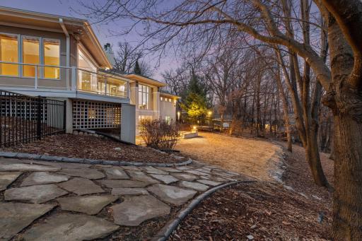 lovely flagstone pathway leads to landscaped and fully fenced in back yard
