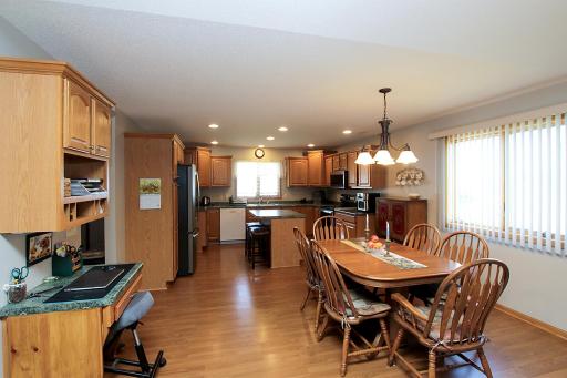 The kitchen opens up to a dining area that includes a built-in desk.