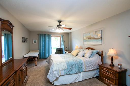 The primary bedroom features a patio door that leads out to the backyard.