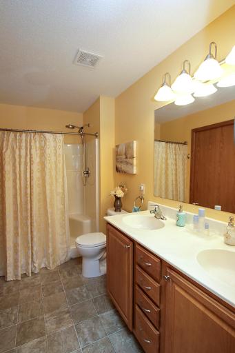 Primary ensuite bathroom features a double sink and a walk-in shower.