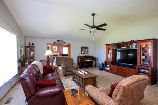 Step into the spacious living room featuring a vaulted ceiling.