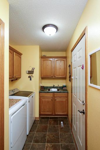 The laundry room features oak cabinets for additional storage.
