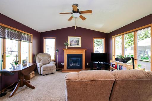 The four-season porch features a gas fireplace. A door leads out to the 11'x27' concrete patio in the backyard.