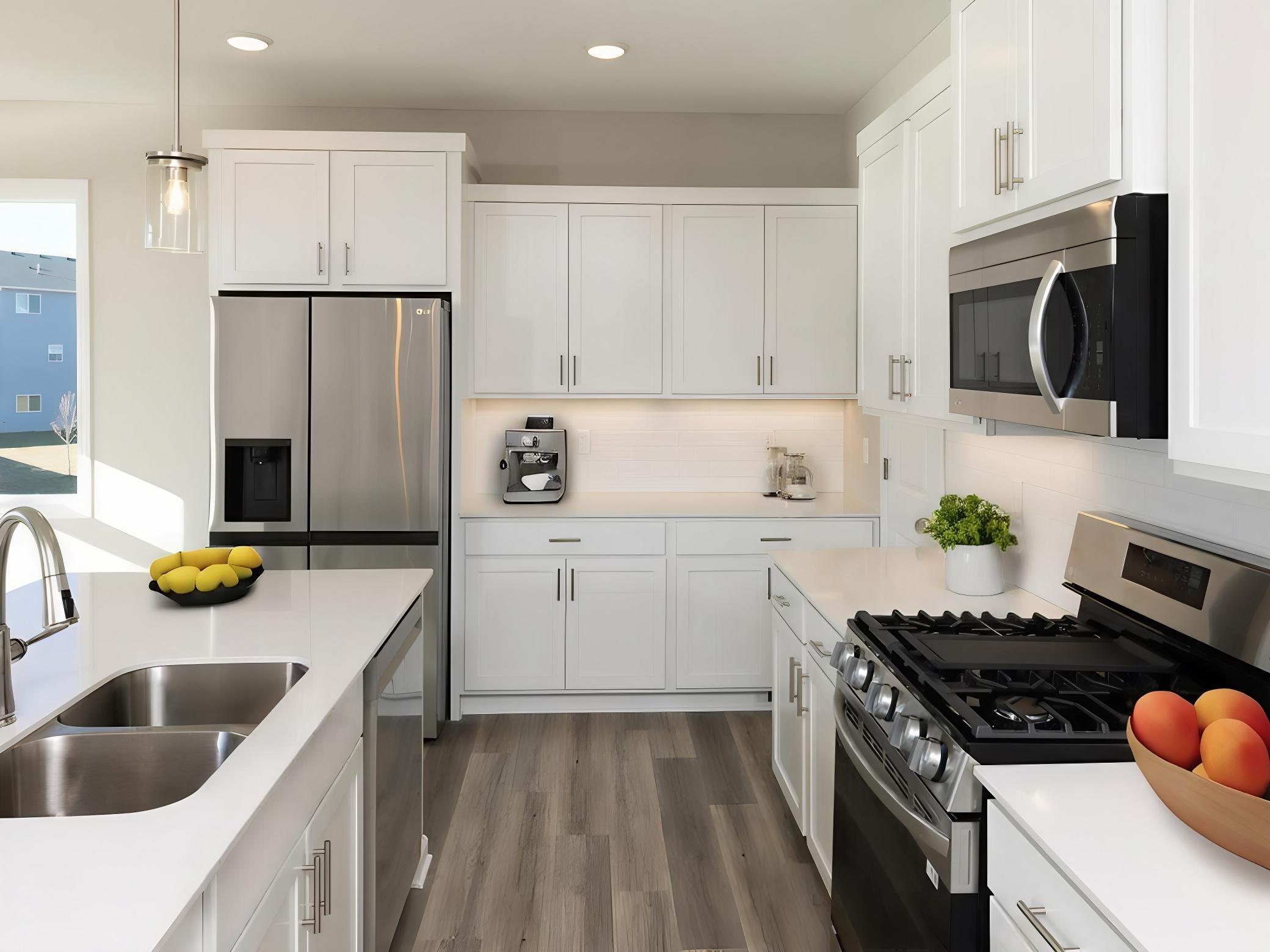 PHOTO OF A DIFFERENT HOME WITH SIMILAR PLAN & FINISHES VIRTUALLY STAGED. Kitchen offers an abundance of counter space. Photo may not depict actual plan, materials, & finishes.