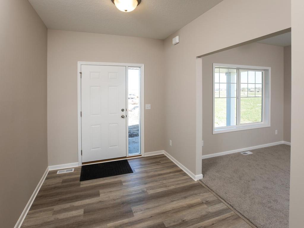 PHOTO OF A DIFFERENT HOME WITH SIMILAR PLAN & FINISHES. Spacious Foyer. Photo may not depict actual plan, materials, & finishes.