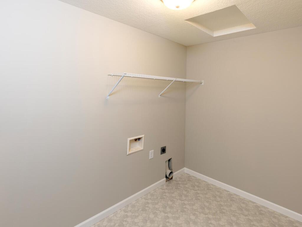 PHOTO OF A DIFFERENT HOME WITH SIMILAR PLAN & FINISHES. Spacious upper level laundry room conveniently located to all the bedrooms. Photo may not depict actual plan, materials, & finishes.