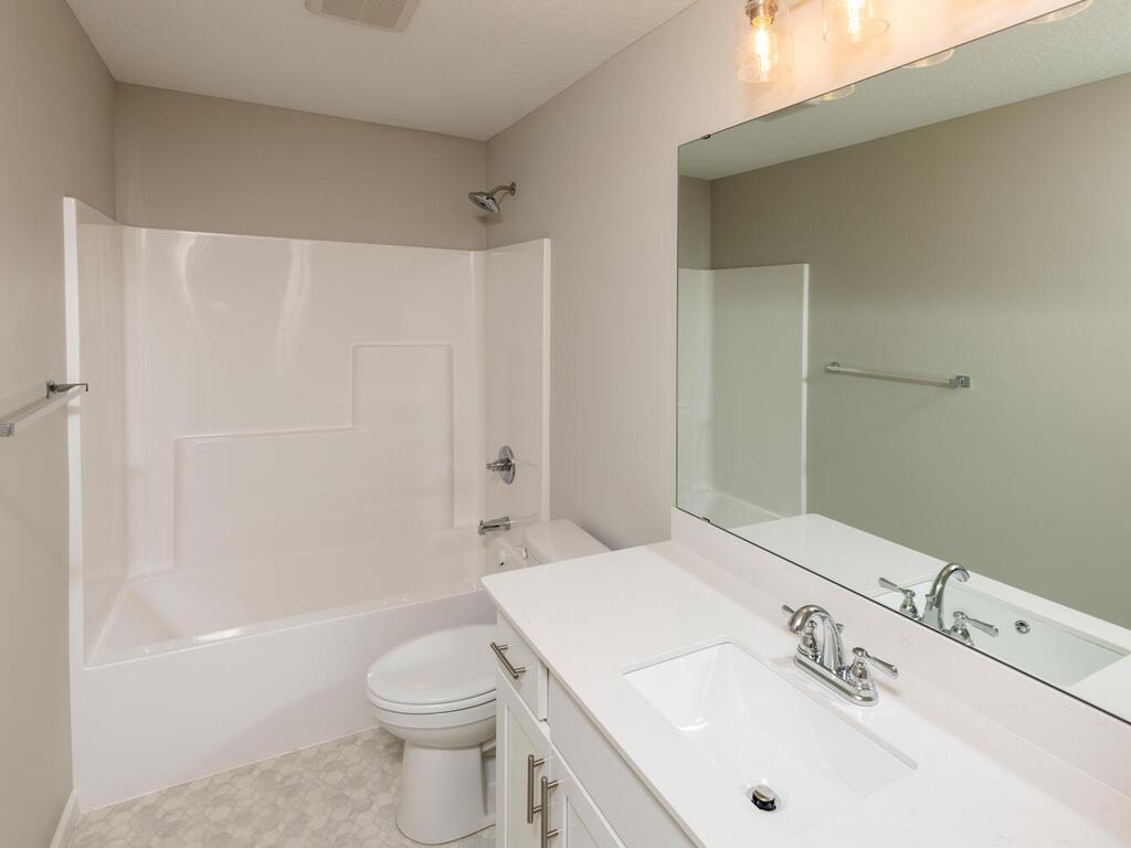 PHOTO OF A DIFFERENT HOME WITH SIMILAR PLAN & FINISHES. Upper level full bath. Photo may not depict actual plan, materials, & finishes.