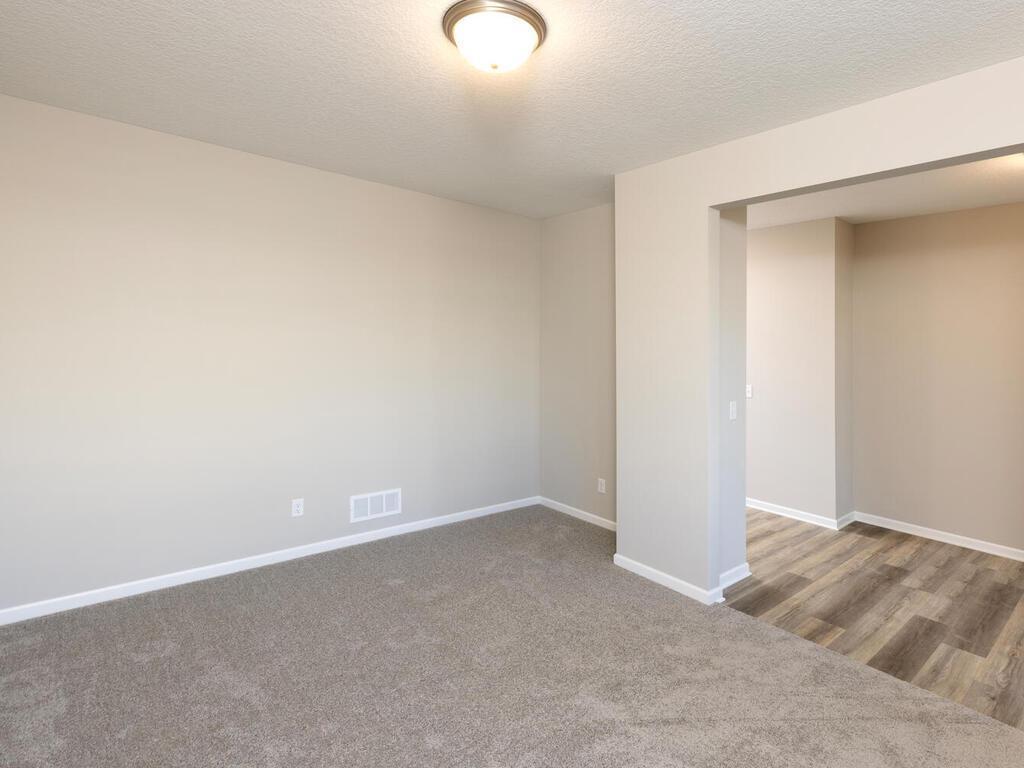 PHOTO OF A DIFFERENT HOME WITH SIMILAR PLAN & FINISHES. Main Floor Flex Room. Photo may not depict actual plan, materials, & finishes.