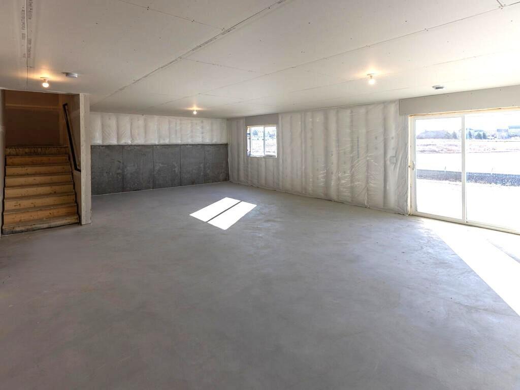 PHOTO OF A DIFFERENT HOME WITH SIMILAR PLAN & FINISHES. Unfinished walkout lower level ready for future finish including a future family room, bedroom 5, flex room, & bath. Photo may not depict actual plan, materials, & finishes.