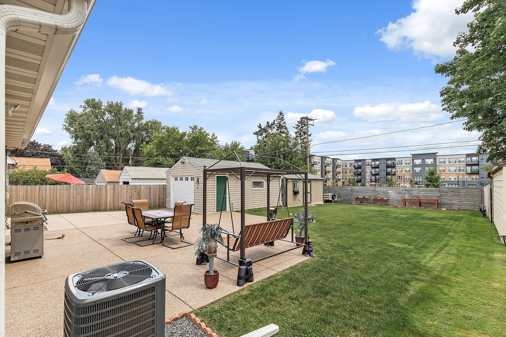 Exterior photos from summer of 2024 showcase the perfectly manicured backyard