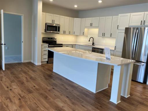 Outfitted with sleek stainless steel appliances and ample cabinetry, this kitchen is both beautiful and practical.