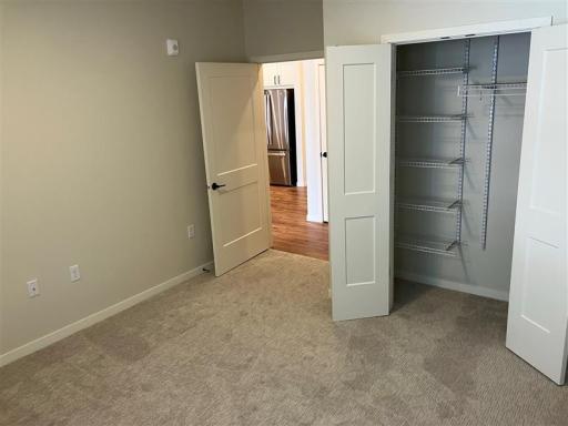 The second bedroom offers versatility, whether used as a guest room, home office, or additional sleeping quarters.