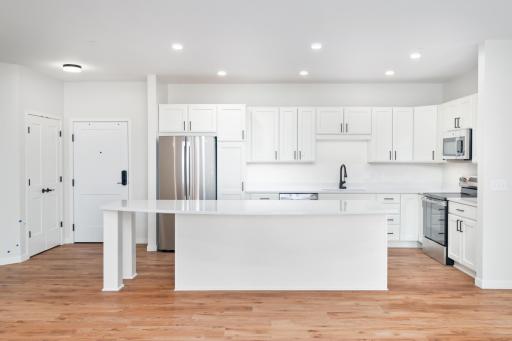 Outfitted with sleek stainless steel appliances and ample cabinetry, this gourmet kitchen is both beautiful and practical.