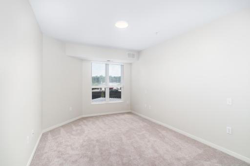 The second bedroom offers versatility, whether used as a guest room, home office, or additional sleeping quarters.