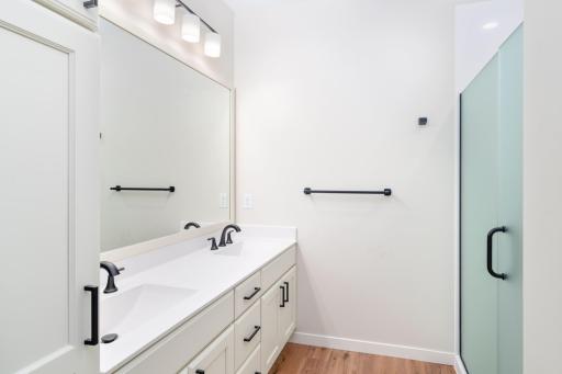 It is complete with a private ensuite 3/4 bath featuring a double vanity, quartz countertops, and a walk-in shower. A generous walk-in closet provides ample storage and organization.