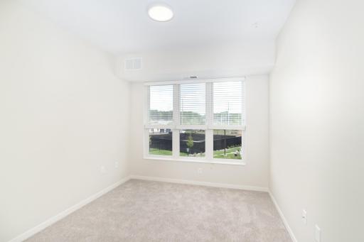 The spacious primary bedroom is a sanctuary of comfort.