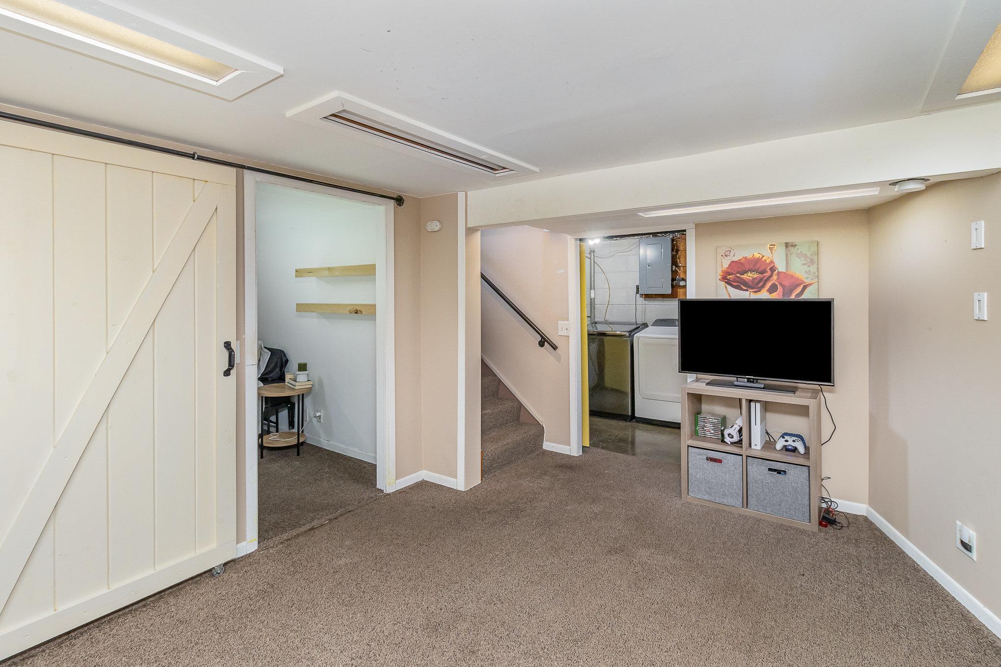 Here's your view from the family room with bedroom #3 to the left, stairs going up and entry to laundry room.