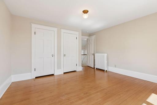 Second floor primary bedroom with two closets.