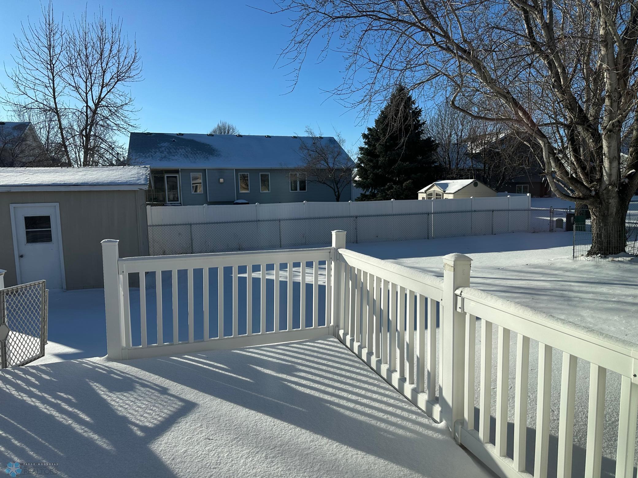 has concrete patio next to the deck