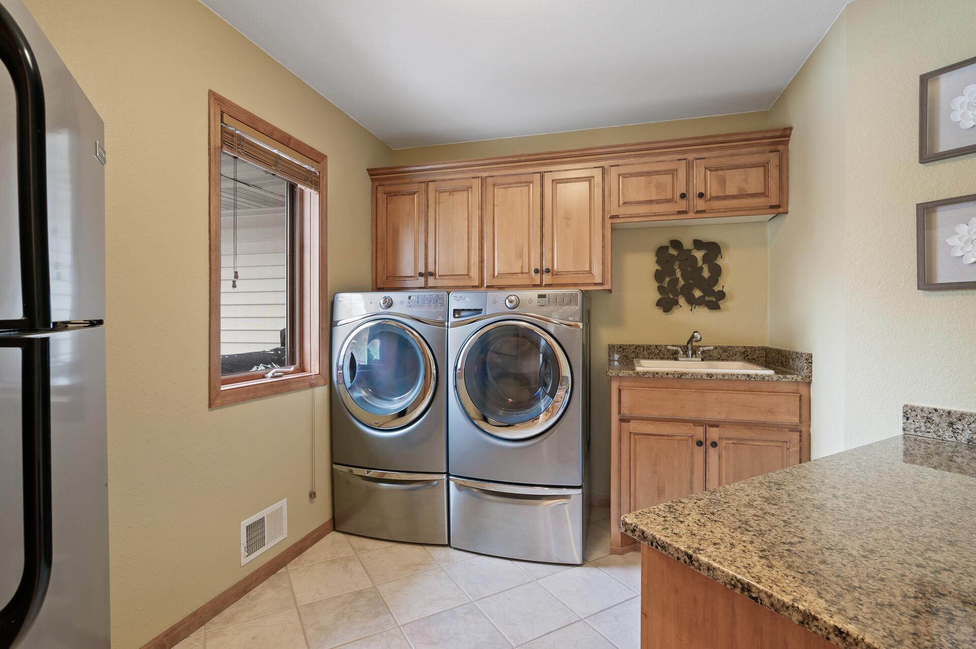 So much space and storage in the main level laundry room! Granite counter tops, beautiful cabinetry!