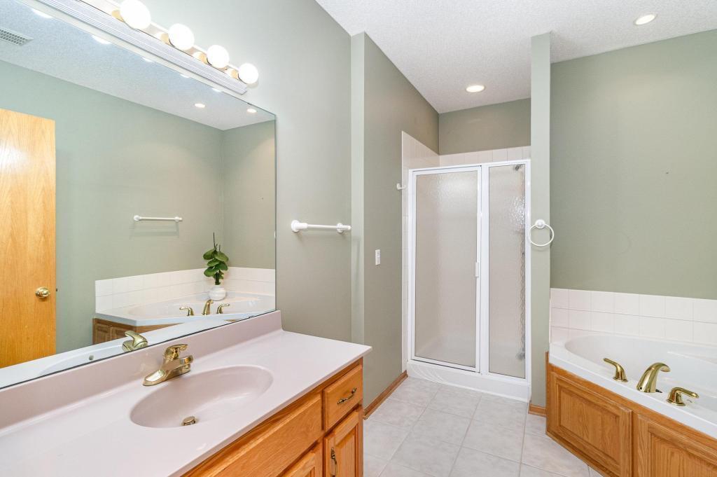652 Aqua Cir small.jpg Primary bathroom with walk in shower and jettd tub.jpg