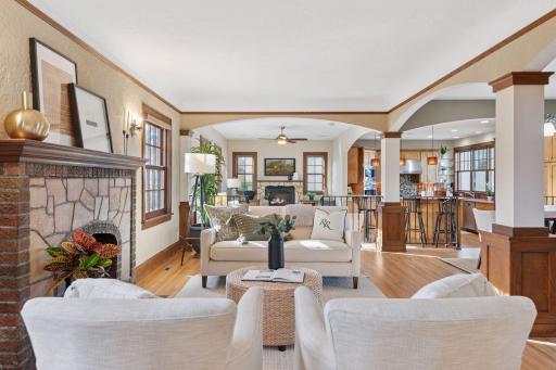 Just inside the foyer the open main floor with beautiful arched openings, hardwood flooring wood & gas fireplaces...