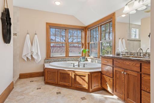 Primary Ensuite - Jetted soaking tub, mirrored medicine cabinet, large walk-in shower and in-floor heat!