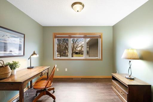 Main floor office with full glass French doors and luxury vinyl plank flooring