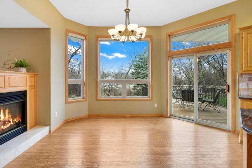 Informal dining area with full glass patio door with access to the maintenance free deck and property.
3-Sided gas fireplace w/ oak mantel