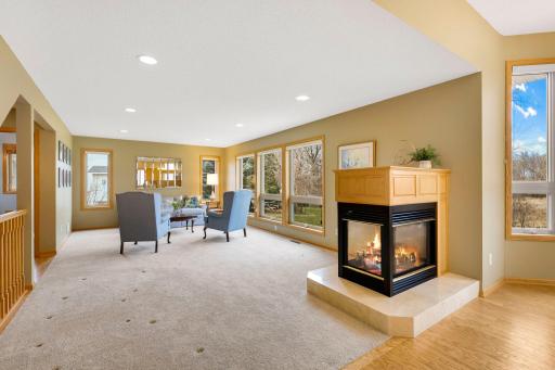 3-Sided Gas fireplace w/ oak mantel properly anchors the main level and can be enjoyed from multiple spaces