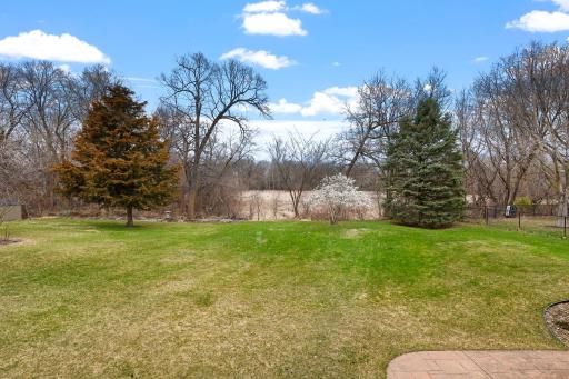 Back of property is naturally wooded and has a protected wetland just beyond its borders