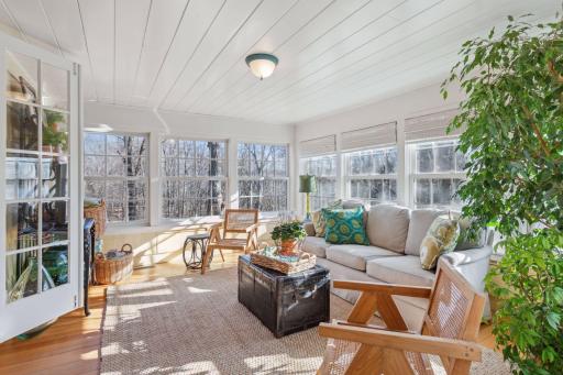 Light filled sunporch with tree top views.