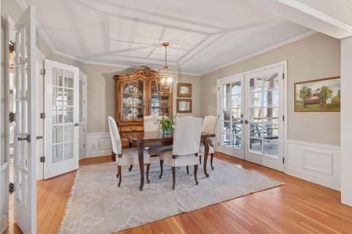Elegant formal dining room opens to the kitchen, living room and screen porch.