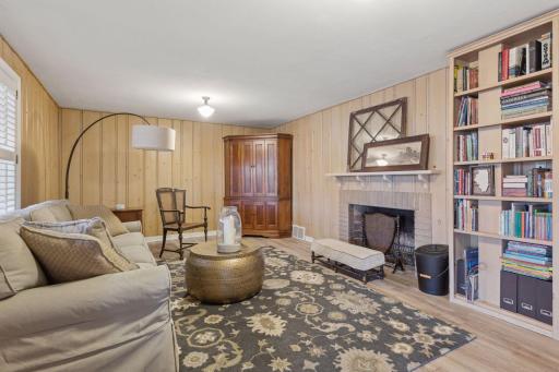 Walk out lower-level family room with built in bookshelves and second wood burning fireplace.
