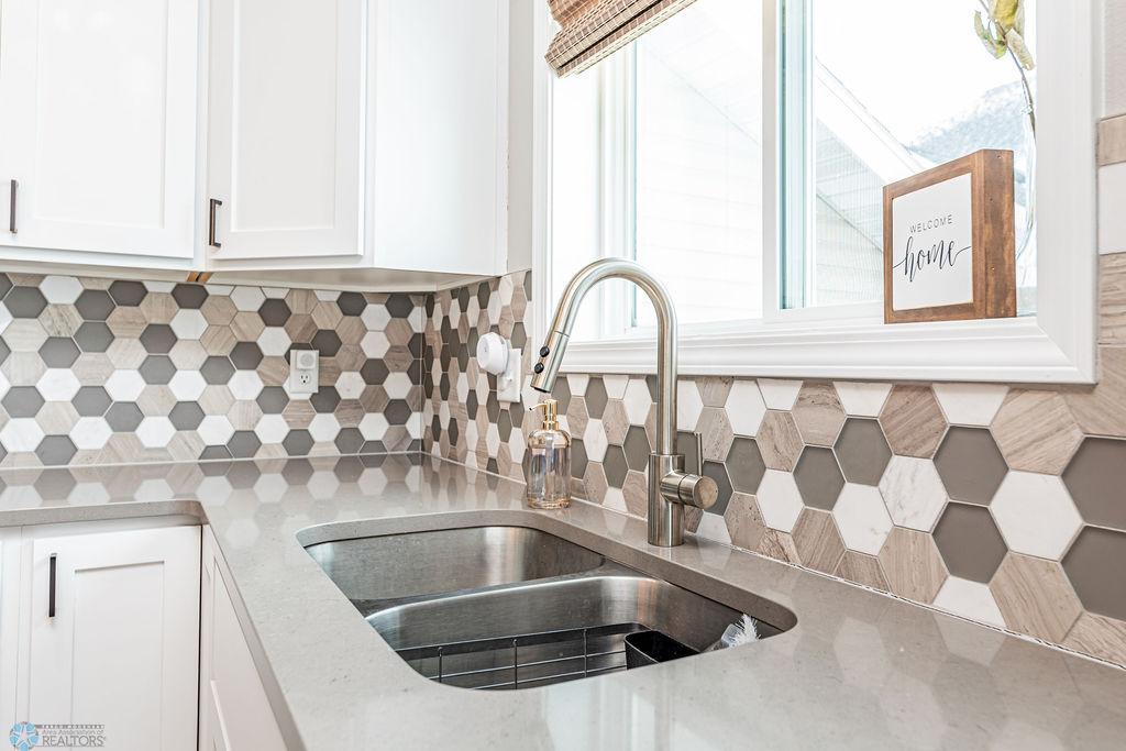 Stone countertops. Stunning tile backsplash. Stainless undermount sink.