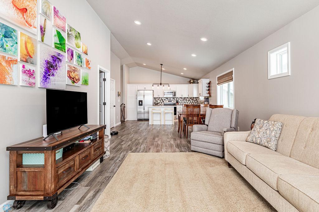 Open-concept. Vaulted ceiling. Recessed lighting. Consistent, easy-maintenance plank floors.