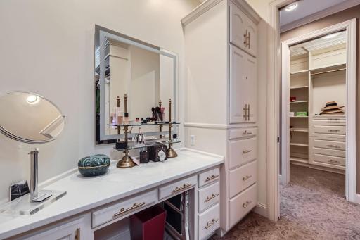 Vanity area in Primary closet with built-in safe. His and her closets.