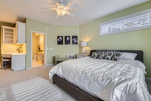Lovely lower bedroom with built-in desk , cabinets and bookshelves. Great views of backyard