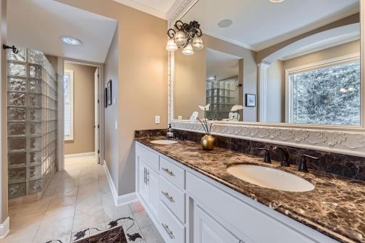Spacious Primary bathroom with granite CT, double sinks and heated floors