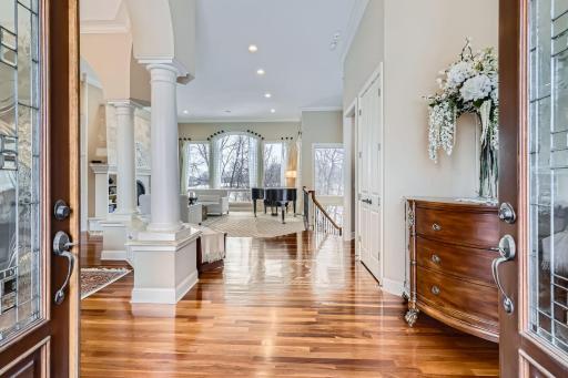 Foyer entry with 12 ft ceilings, pillars and beautiful cherry woodwork